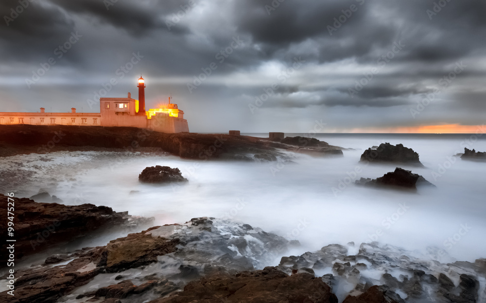End day with storm and the lighthouse illuminating the early evening