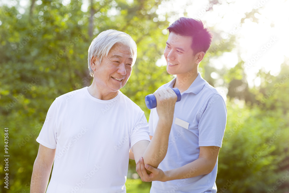 Senior man exercising with dumbbell in nursing home Senior man exercising with dumbbell in nursing home