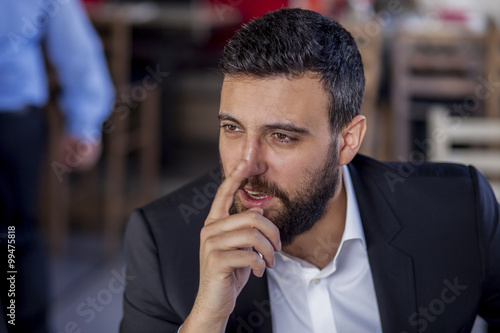 Portrait of a handsome businessman,sitting and thinking with concentrating. Shallow depth of field