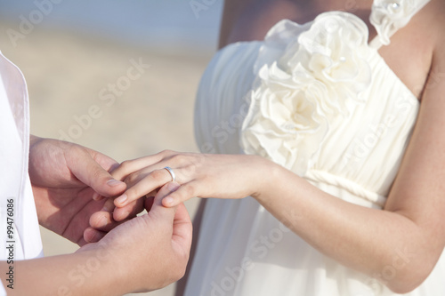 Young newlyweds admire ring