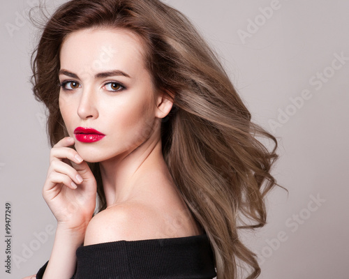 Portrait of beautiful blonde woman with curly hairstyle and bright makeup, perfect skin, skincare, spa, cosmetology. Sexy vogue woman face, sensual beauty girl model. Natural look. studio, isolated.
