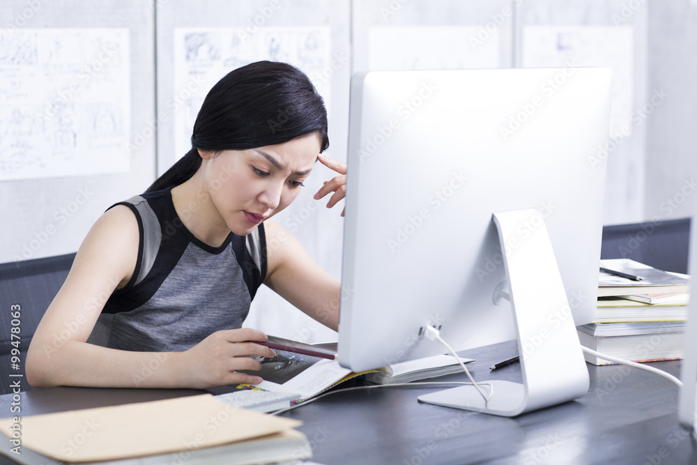 Fototapeta premium Young woman thinking in office