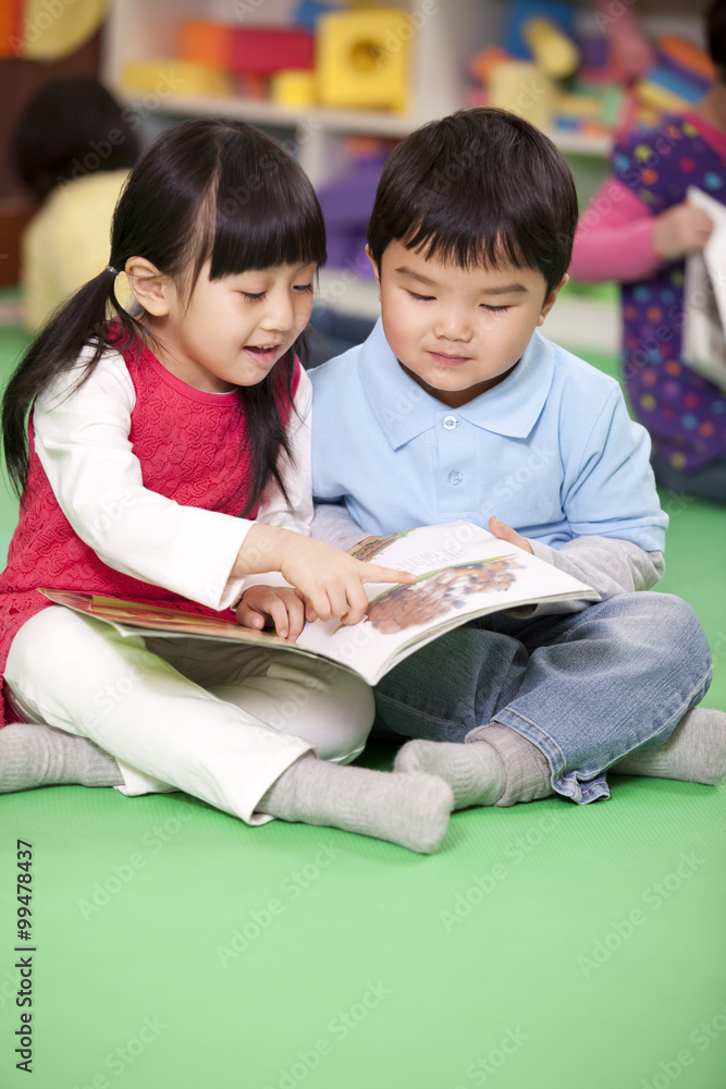 Cute little girl and little boy reading books Cute little girl and little boy reading books