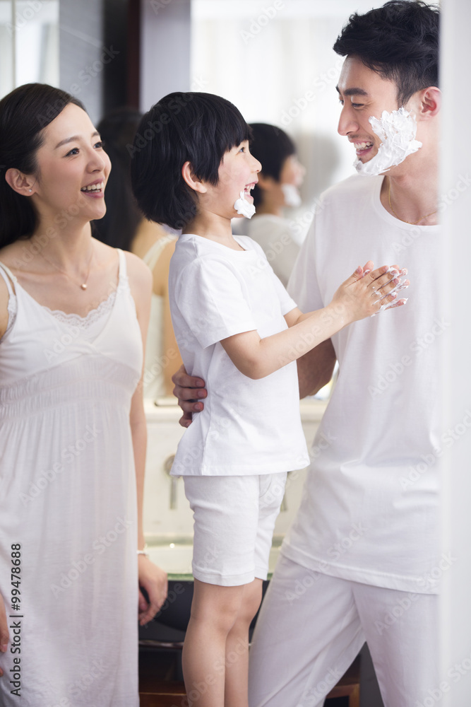 Family in bathroom with shaving cream on chin Family in bathroom with shaving cream on chin