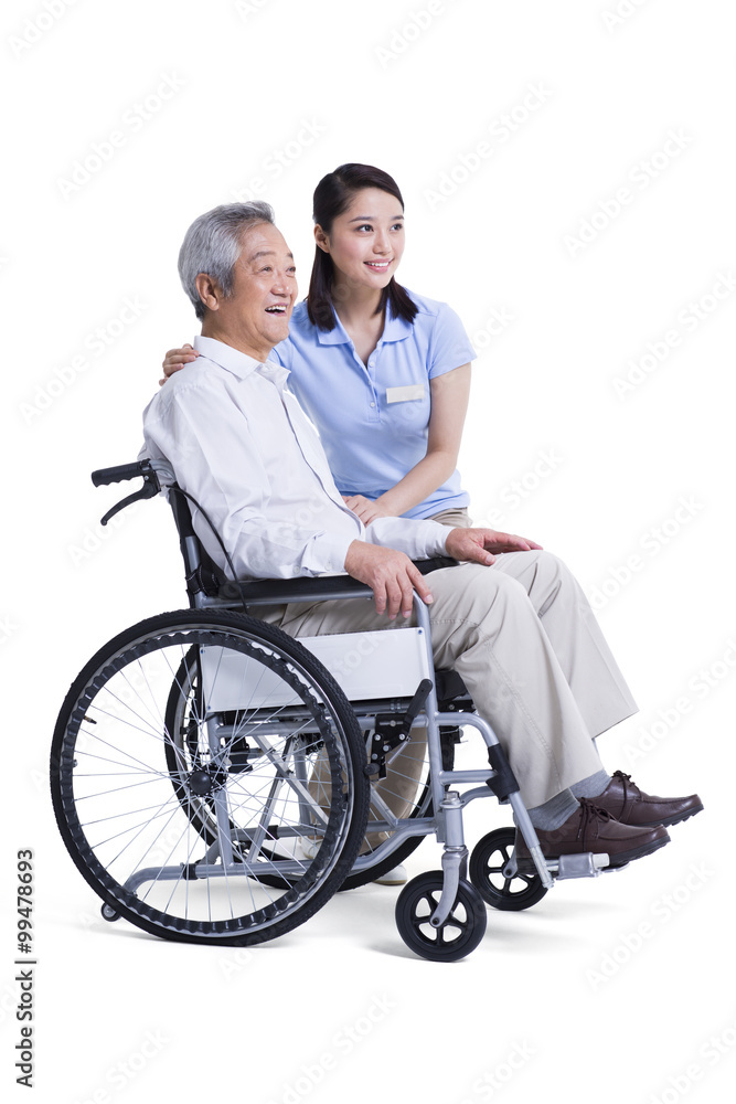 Female nursing assistant taking care of senior in wheelchair Female nursing assistant taking care of senior in wheelchair