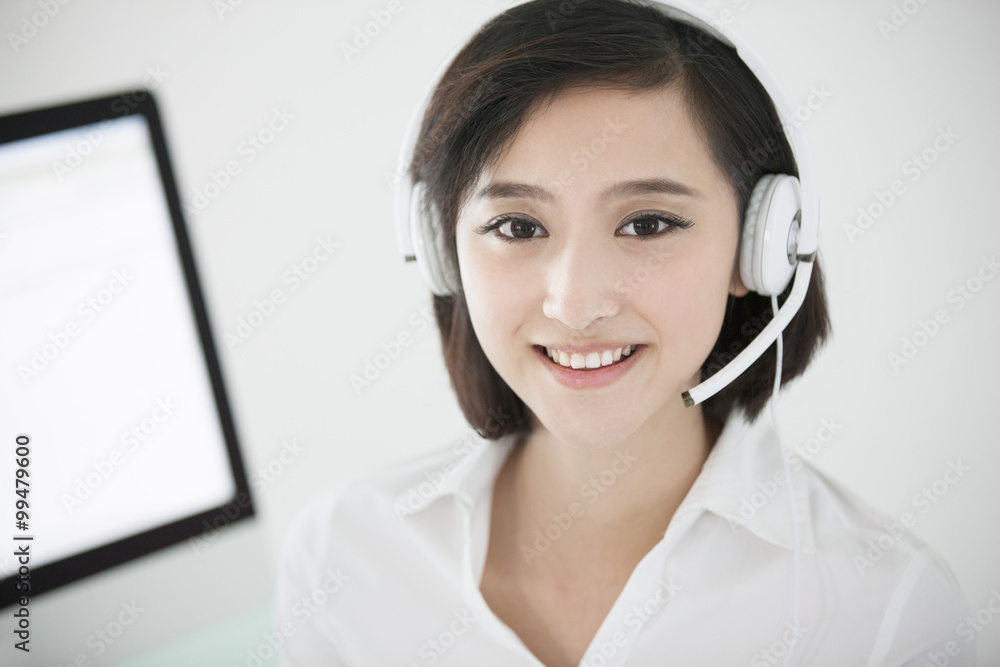 Cheerful businesswoman with headset in office Cheerful businesswoman with headset in office