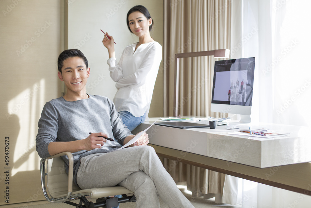 Fototapeta premium Young couple designing clothing together