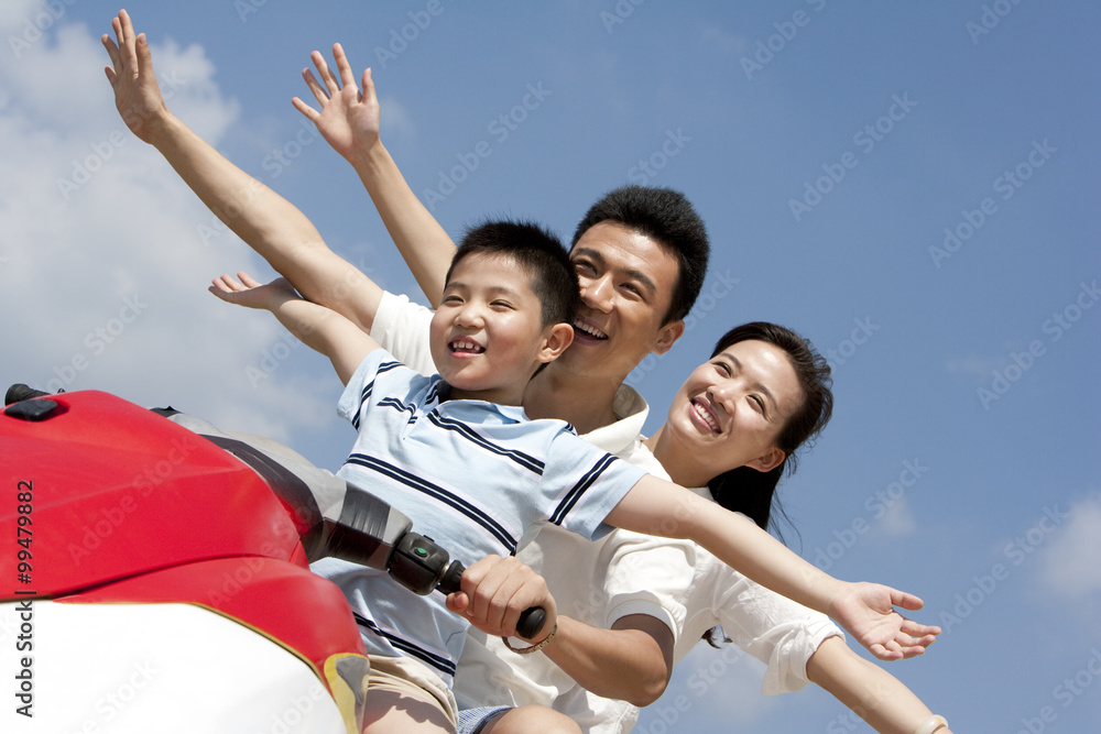 Fototapeta premium Happy family riding on a jet ski