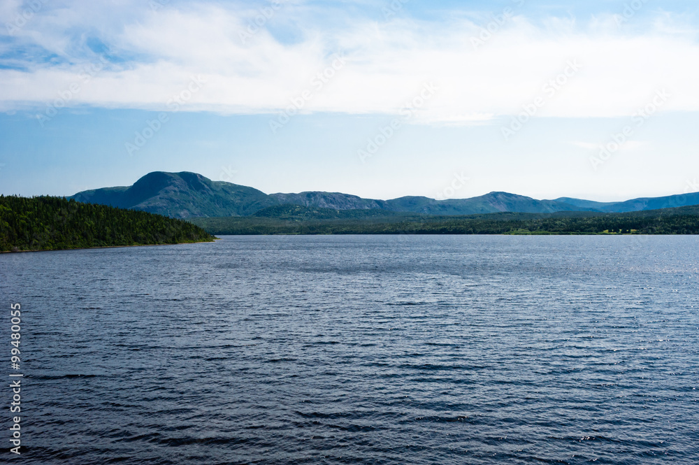 Lake among forested hills and mountain