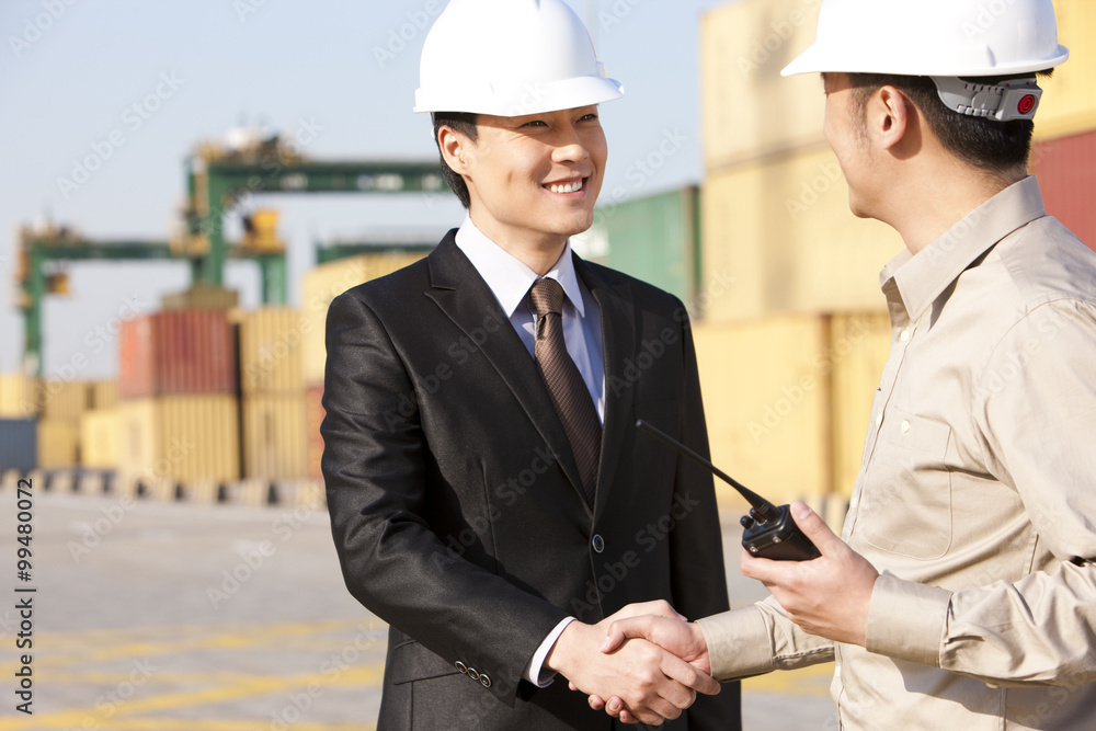 businessman and shipping industry worker shaking hands businessman and shipping industry worker shaking hands