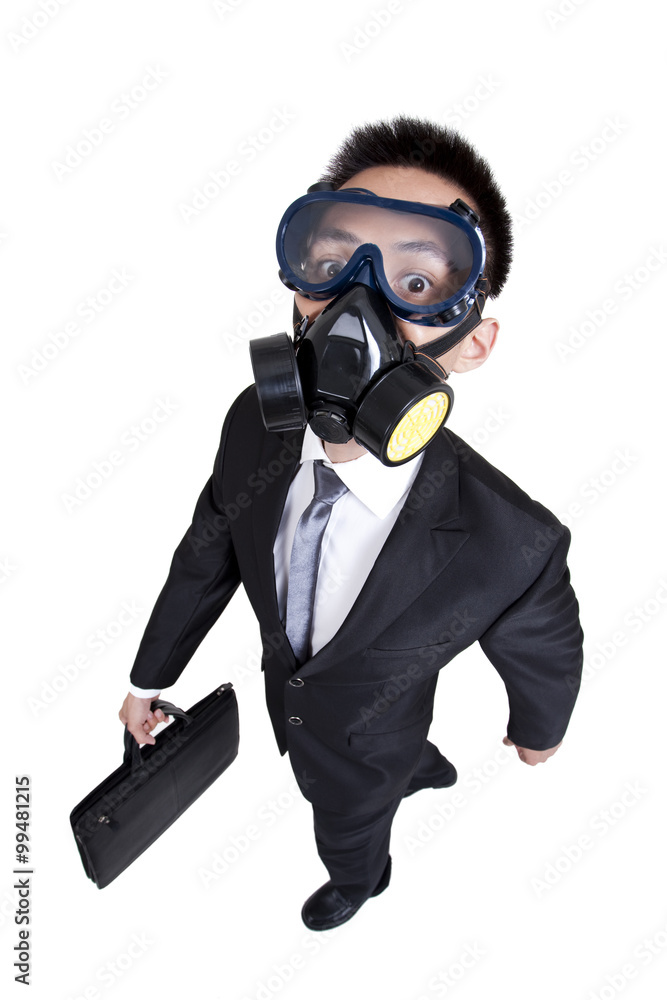Young businessman with gas mask on the move Young businessman with gas mask on the move