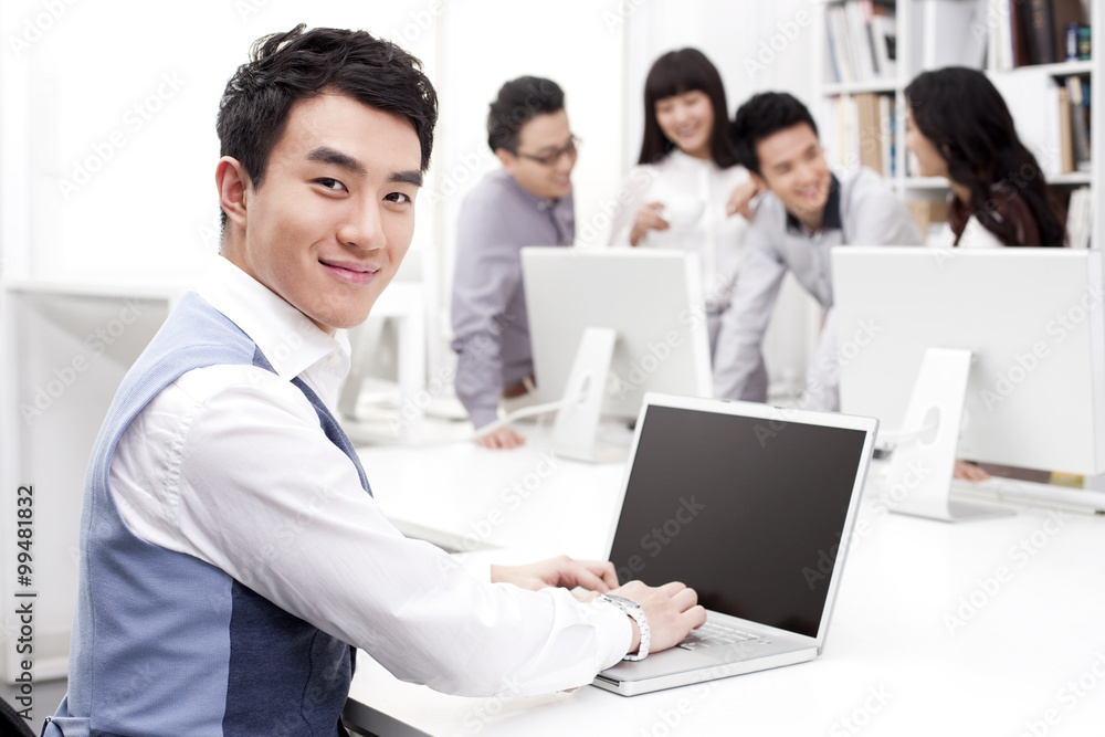 Male office worker using laptop in studio Male office worker using laptop in studio