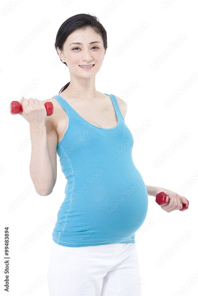 Young pregnant woman exercising with dumbbells Young pregnant woman exercising with dumbbells