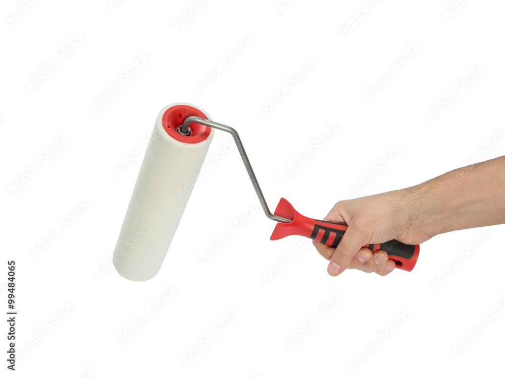Naklejka premium Paint roller in man's hand