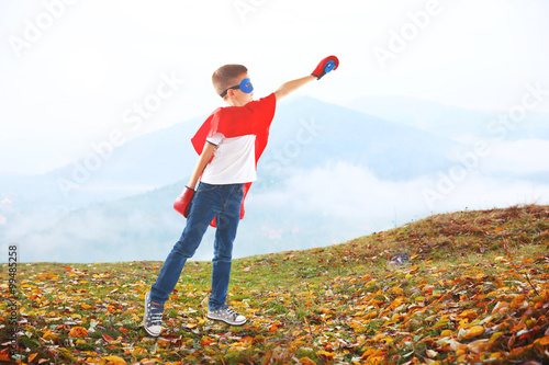 Boy dressed as superhero wi...