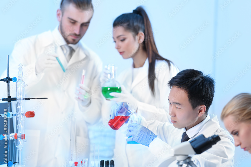 Young medical technicians working in laboratory Young medical technicians working in laboratory