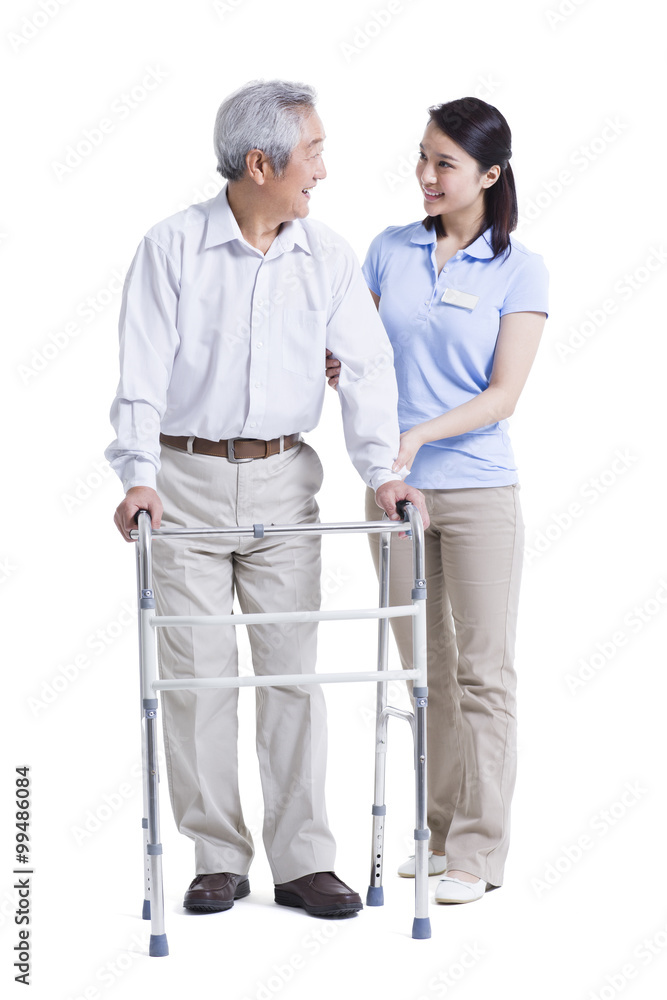 Female nursing assistant helping senior man with walking frame Female nursing assistant helping senior man with walking frame