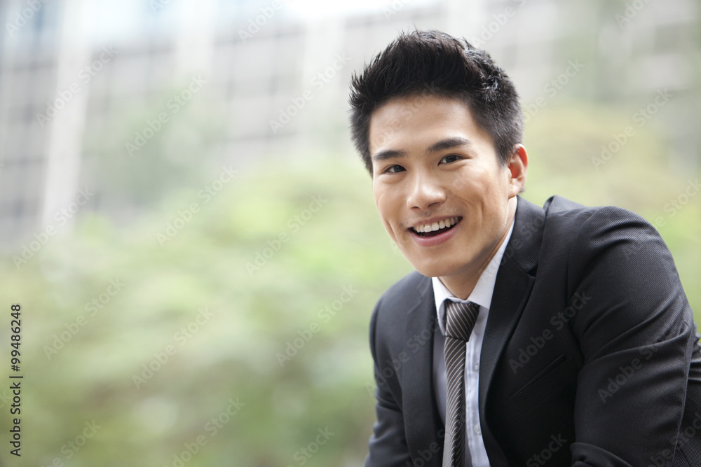 Portrait of cheerful young businessman outdoors, Hong Kong Portrait of cheerful young businessman outdoors, Hong Kong