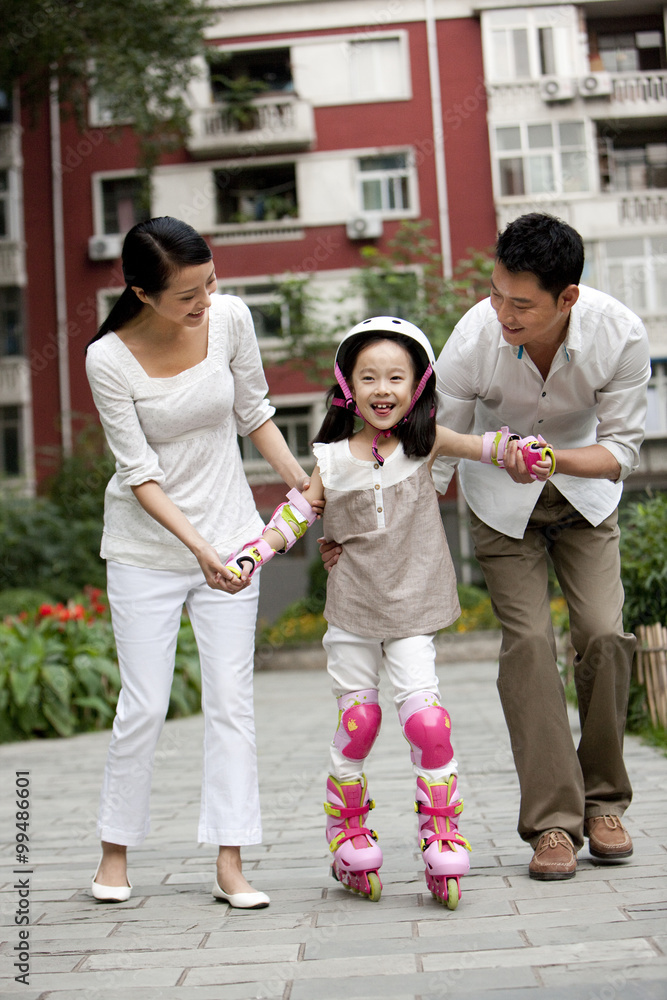 Chinese family with daughter in rollerblades