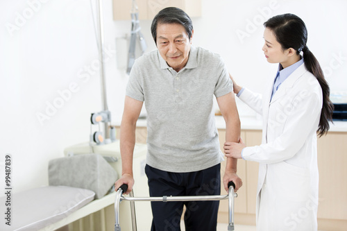 Doctor helping patient with walker