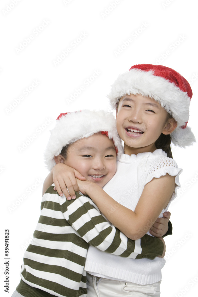 Boy and girl with Santa hats Boy and girl with Santa hats