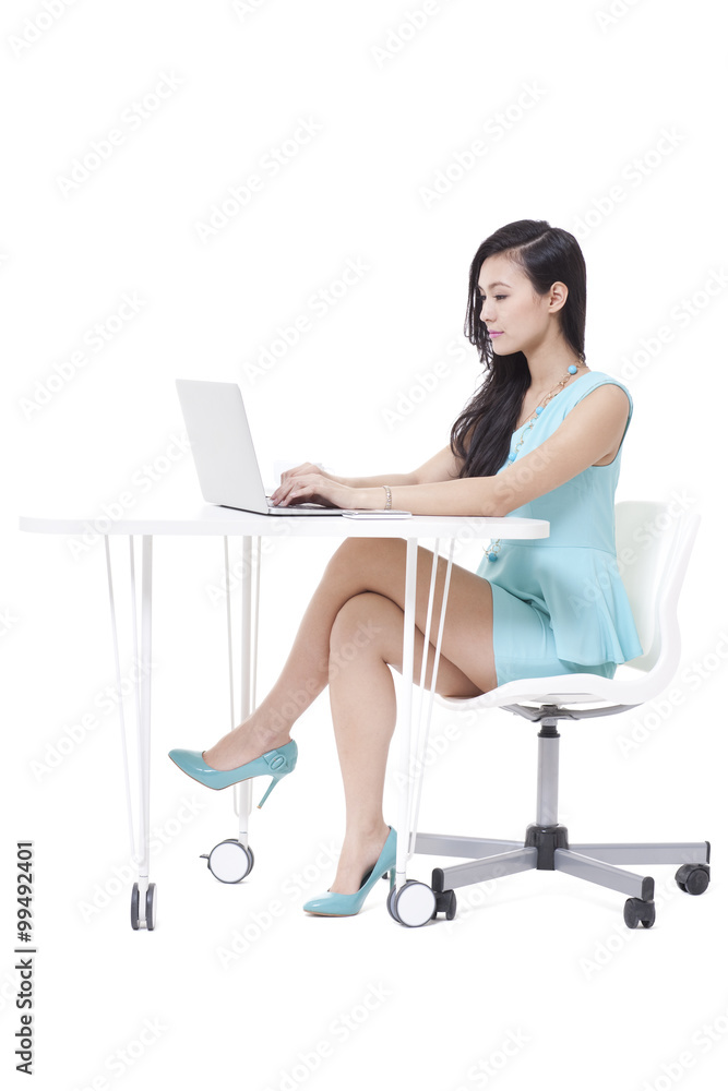 Fashionable businesswoman using laptop in office Fashionable businesswoman using laptop in office