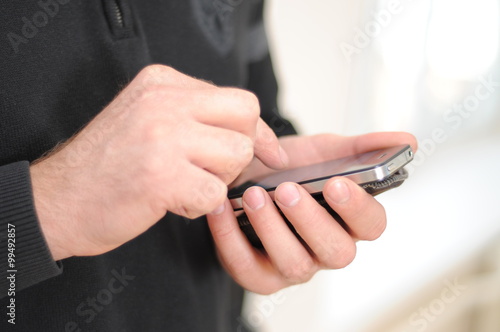 Man hold phone in hands and typing, chatting photo