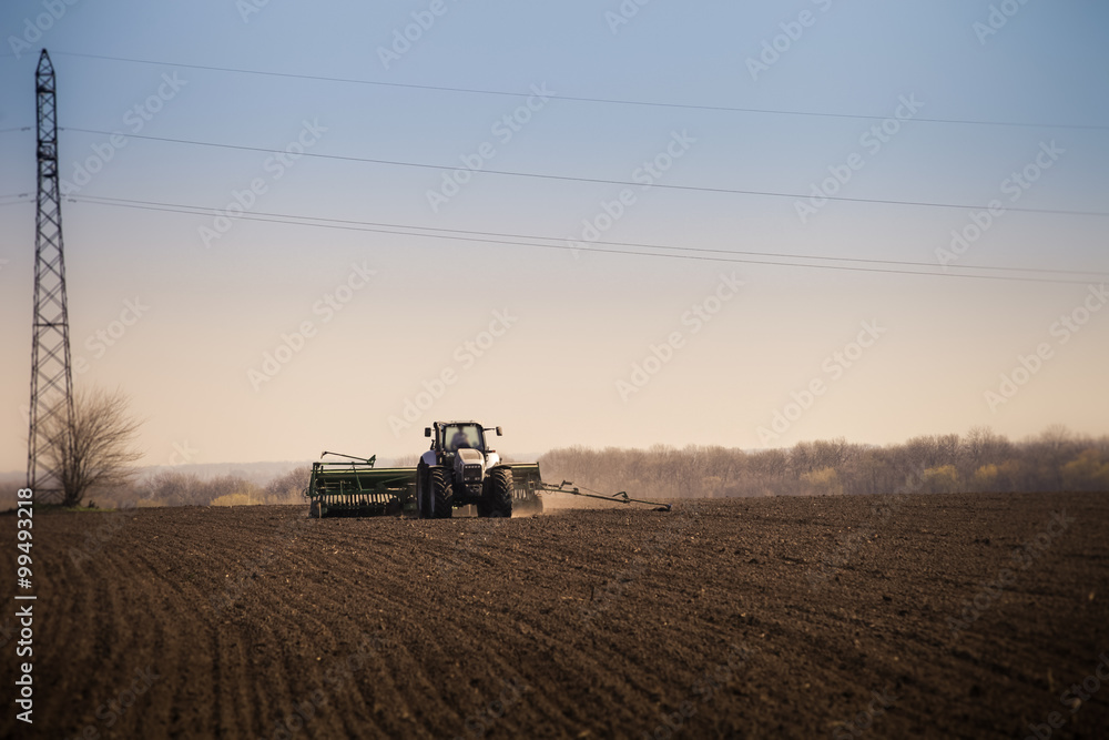 Fototapeta premium panorama of operating tractor in field