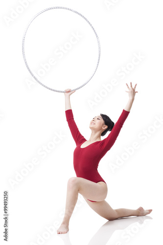 Female rhythmic gymnast performing with hoop © Blue Jean Images