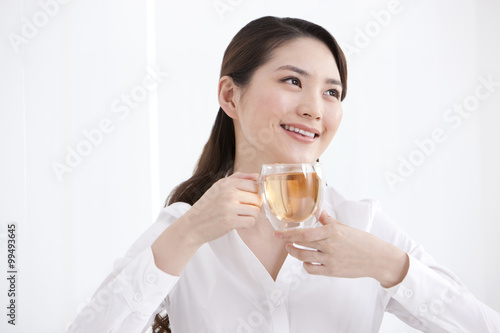 Young businesswoman having tea