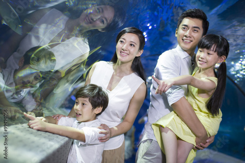 Young family in aquarium