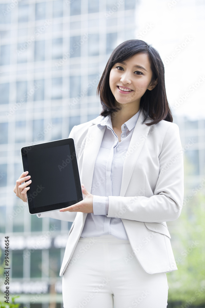 Young businesswoman holding digital tablet Young businesswoman holding digital tablet
