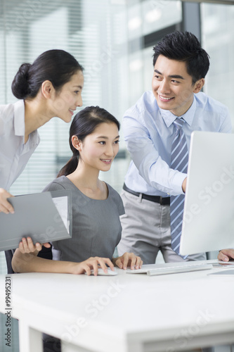 Young business people using computer in office