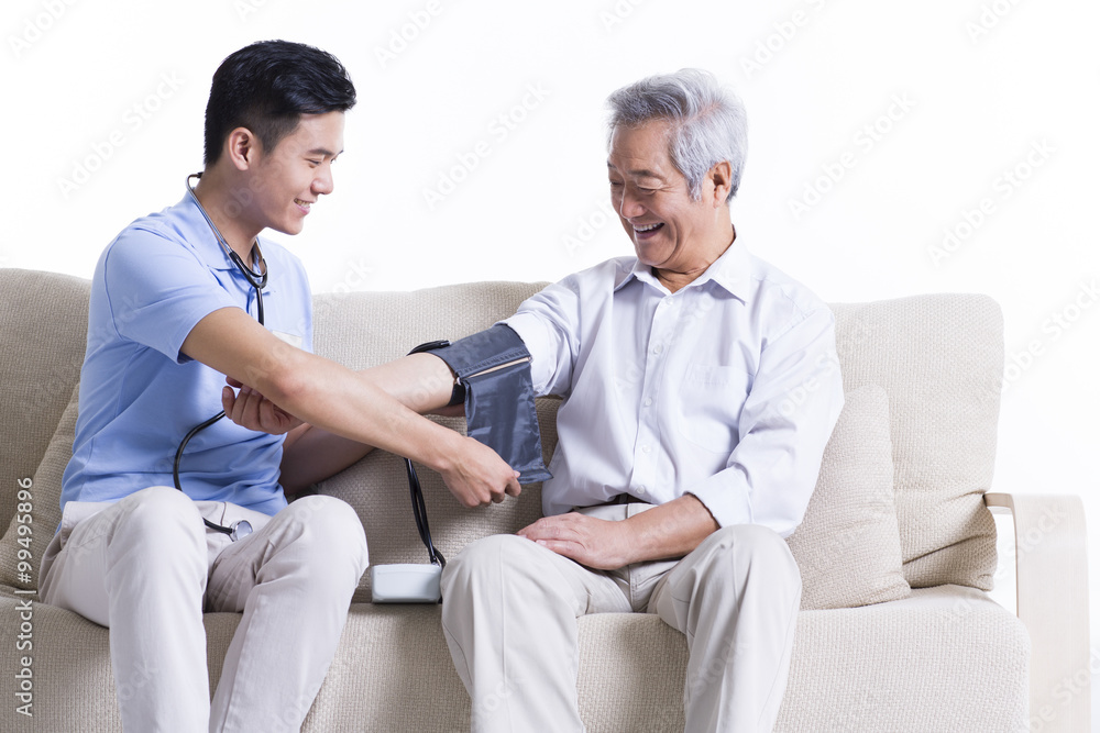 Nursing assistant taking senior man's blood pressure Nursing assistant taking senior man's blood pressure