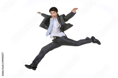 Young businessman jumping in mid-air