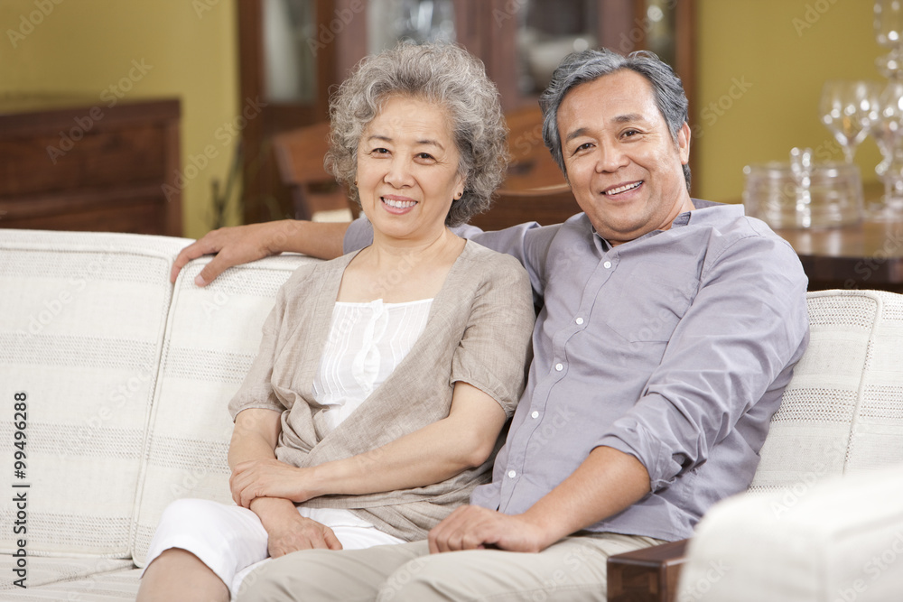 Portrait of senior couple sitting in sofa Portrait of senior couple sitting in sofa