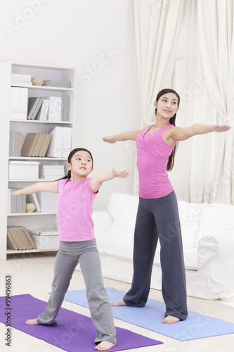 Monther and daughter doing yoga