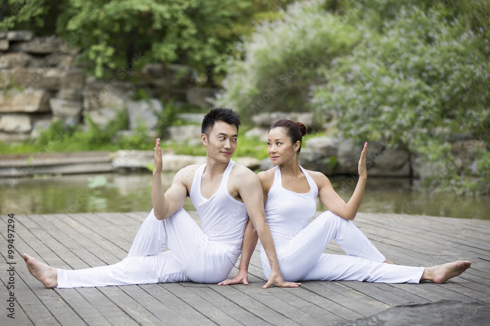 Young couple doing yoga Young couple doing yoga