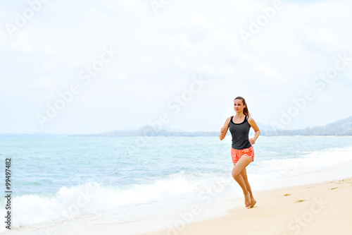 Sports. Fit Female Athlete Jogger Running On Beach. Sporty Athletic Woman Jogging During Workout Outside. Fitness, Exercising, Healthy Lifestyle. Health Concept