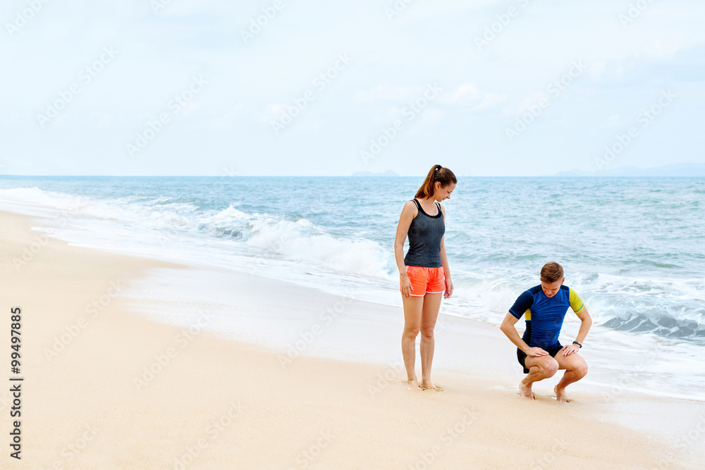 Fitness Exercises. Healthy Couple Squatting, Exercising On Beach
