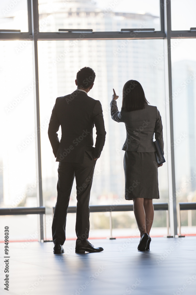 Business person looking through window Business person looking through window
