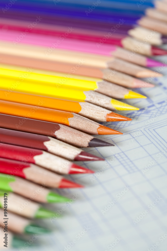 Color pencils in a neat row on blueprint Color pencils in a neat row on blueprint