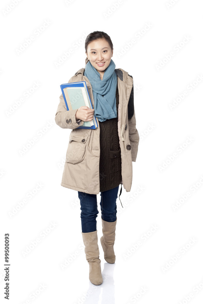 A young female student holding books, white background A young female student holding books, white background
