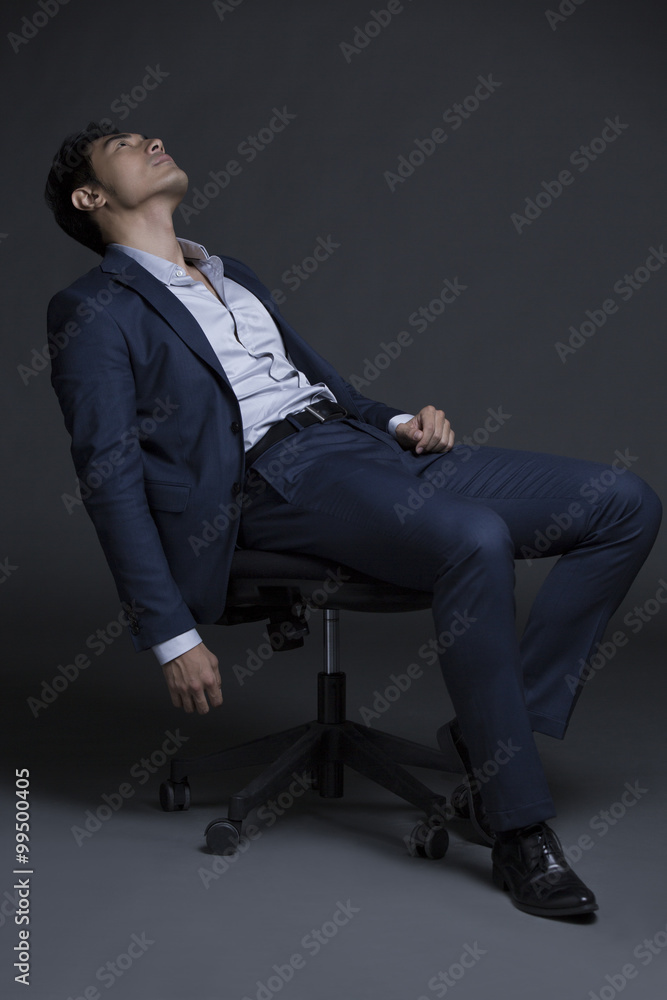 Tired businessman in chair Tired businessman in chair