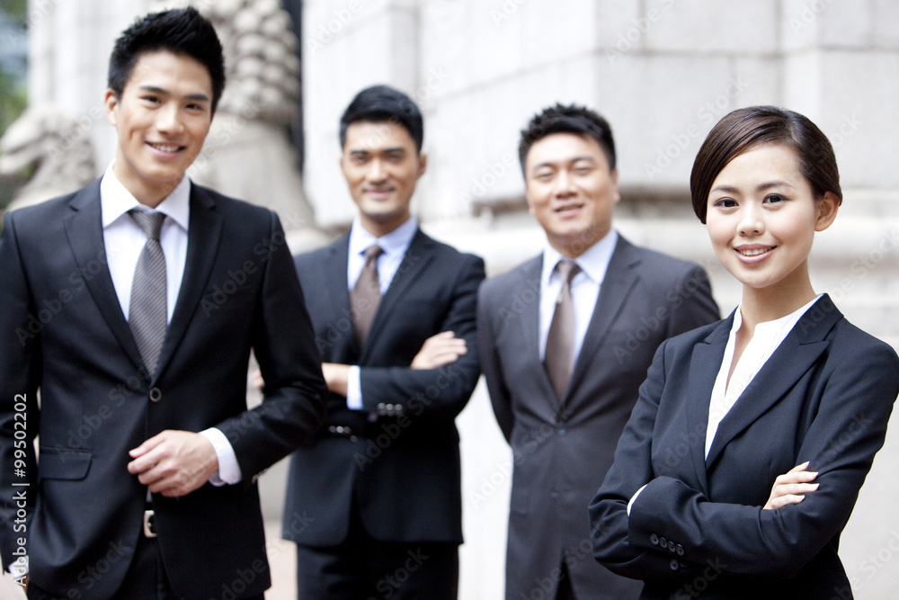 Portrait of confident business team outside a building, Hong Kong Portrait of confident business team outside a building, Hong Kong