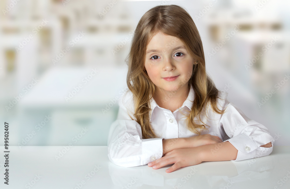 Child girl at desk in classroom background empty space. Child girl at desk in classroom background empty space.
