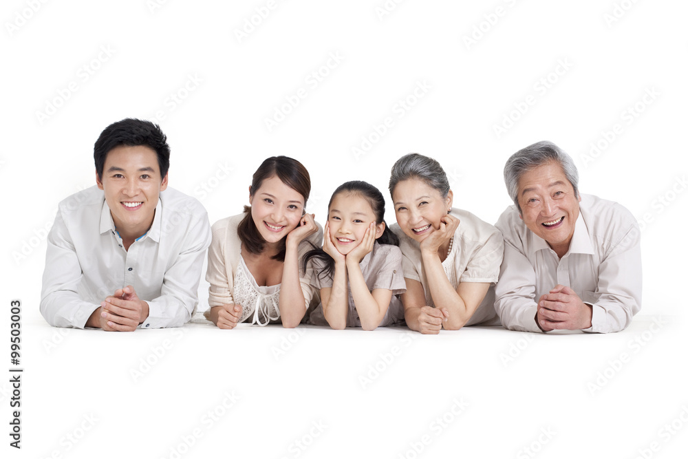Happy family lying on front, studio shot Happy family lying on front, studio shot