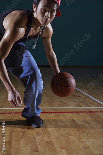Hip Young Man Playing Basketball On Court © Blue Jean Images