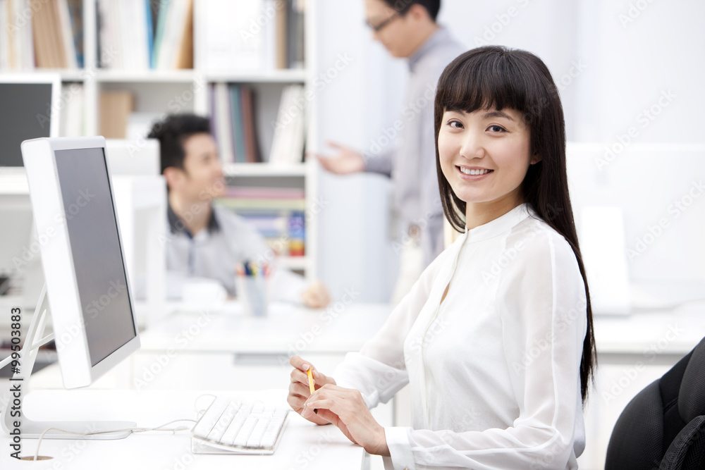 Happy young business colleagues at work in the office Happy young business colleagues at work in the office