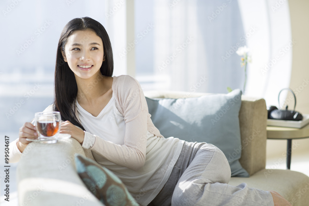 Happy young woman drinking black tea Happy young woman drinking black tea